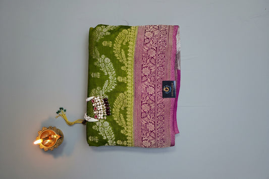 Semi crepe georgette banarasi saree with golden Zari. Mehedi color and rani pink border.