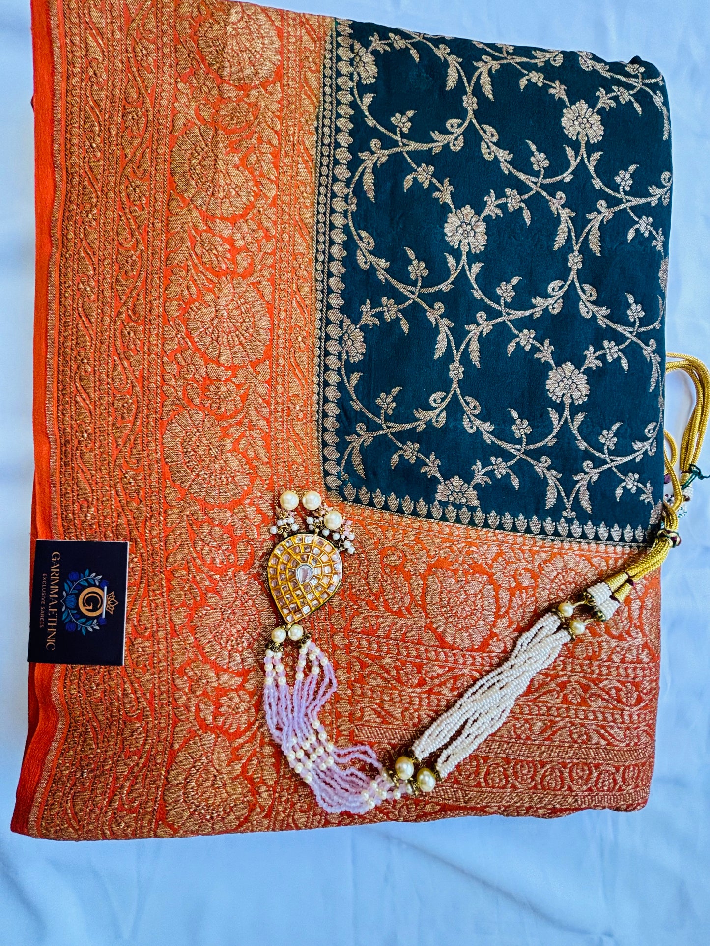 Semi crepe georgette banarasi saree with golden Zari. Mehedi color and rani pink border.