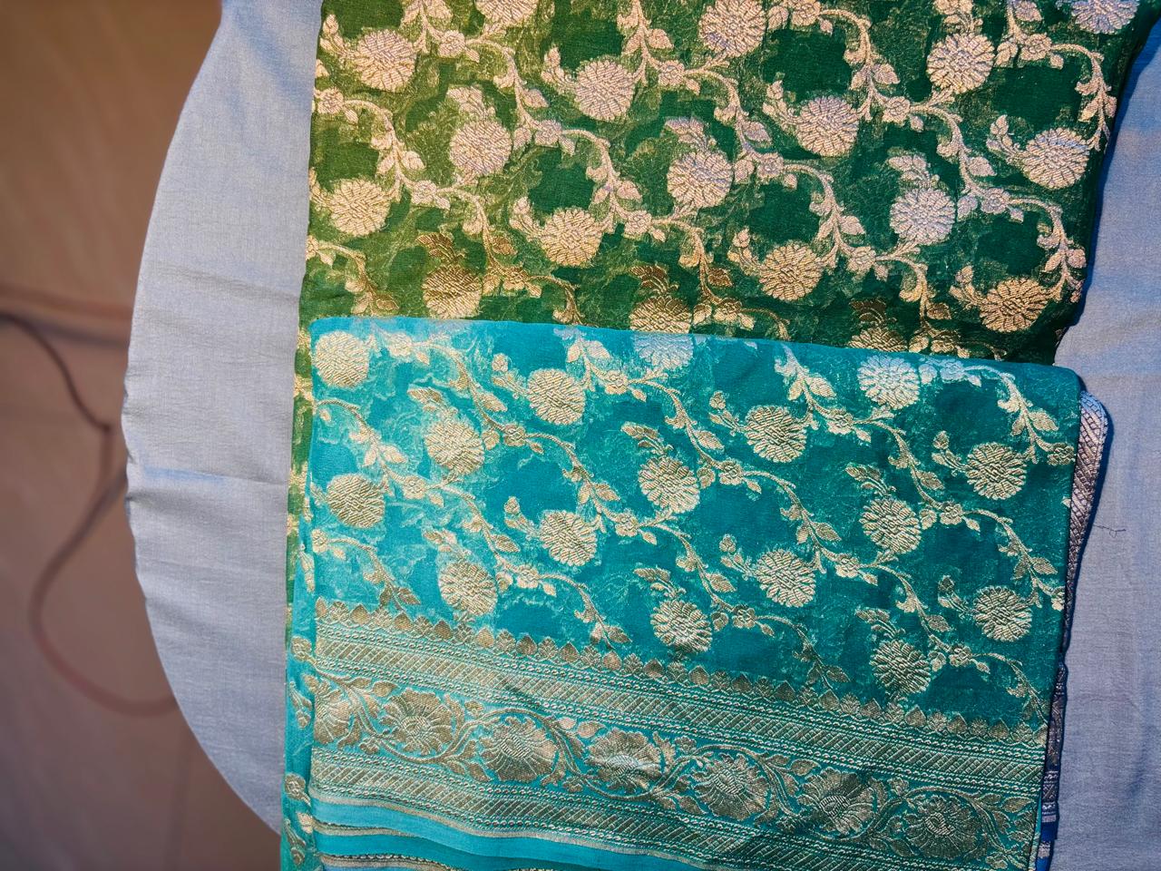 pure khaddi georgette jaal pattern multiheaded pure benarasi sareee. color is blue and green shades merge with each other