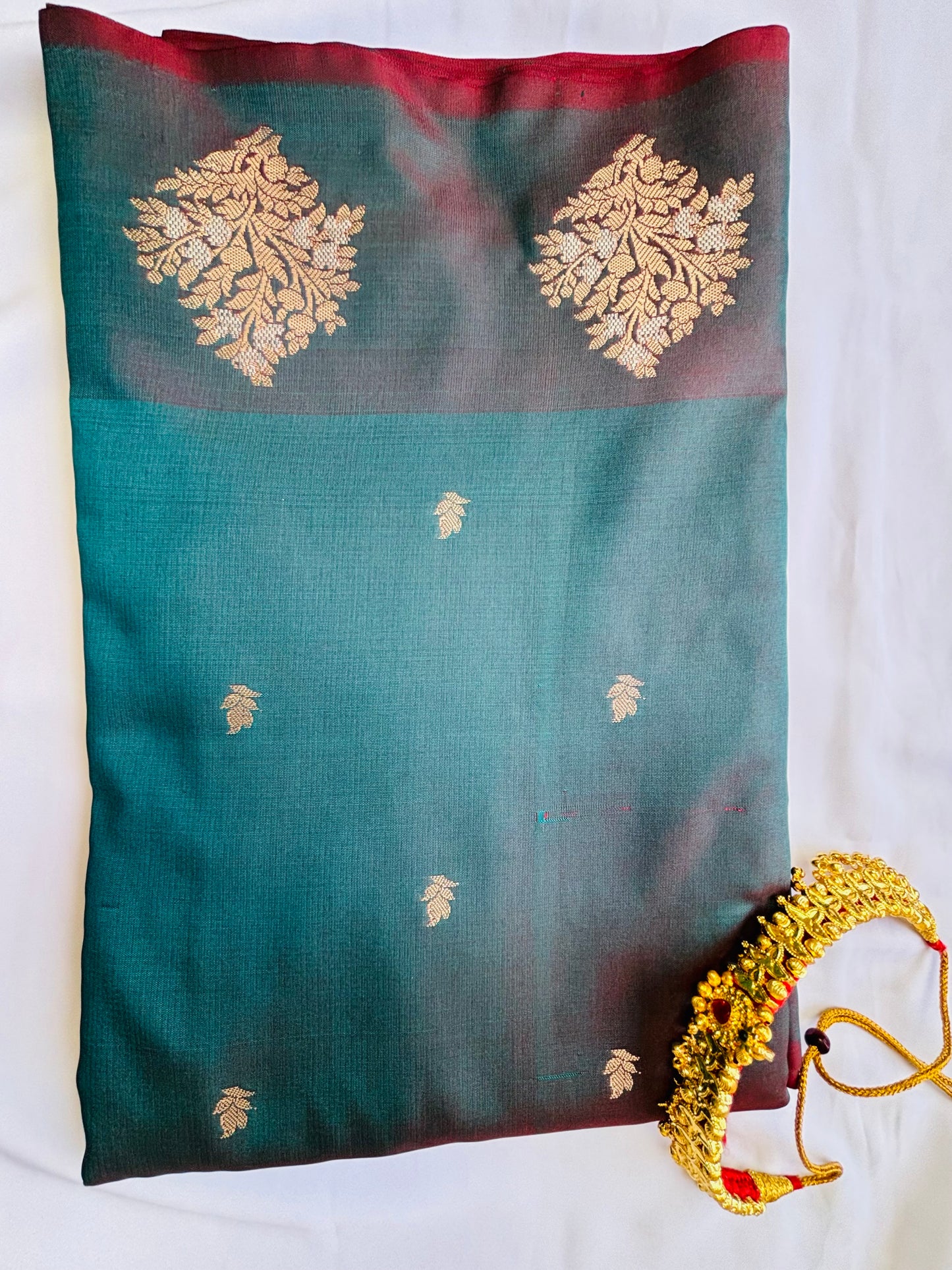 Banarasi silk blue saree with golden zari work.