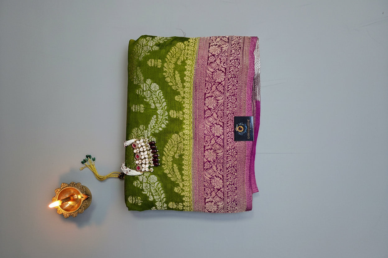 Semi crepe georgette banarasi saree with golden Zari. Mehedi color and rani pink border.