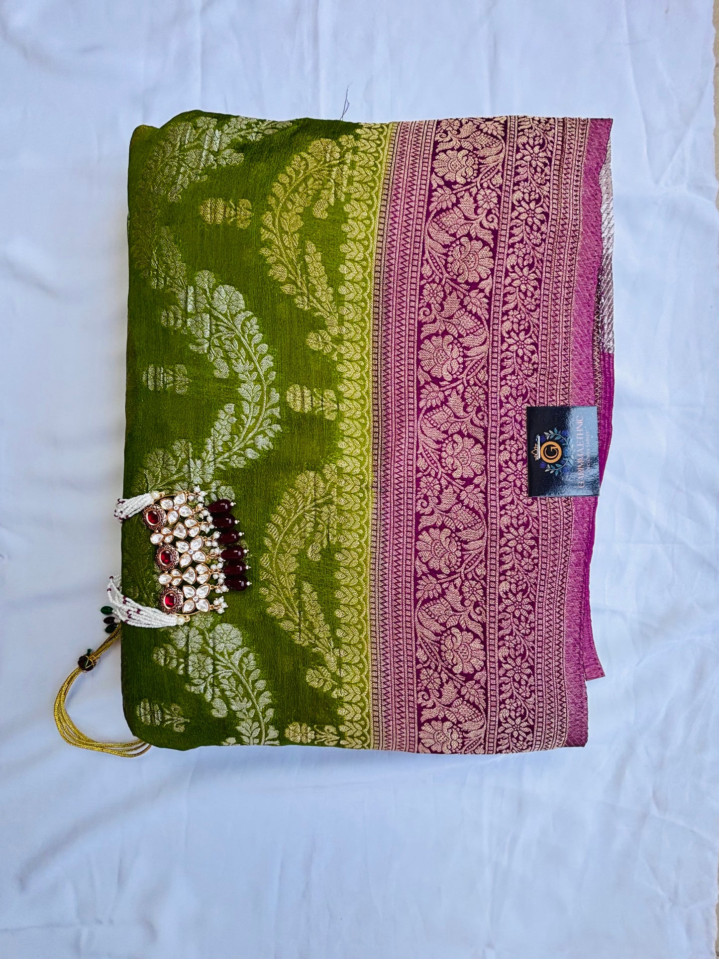 Semi crepe georgette banarasi saree with golden Zari. Mehedi color and rani pink border.