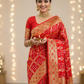 Semi goergette dark orange bandhani saree with rani pink and orange minakari work  golden  zari work