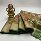 Mehandi color organza banarasi saree. golden zari work and red and rani pink mina work.