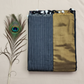 "Elegant Linen Cotton Saree featuring a rich golden zari patta border, beautifully finished with tassels on the pallu, available in vibrant colours."