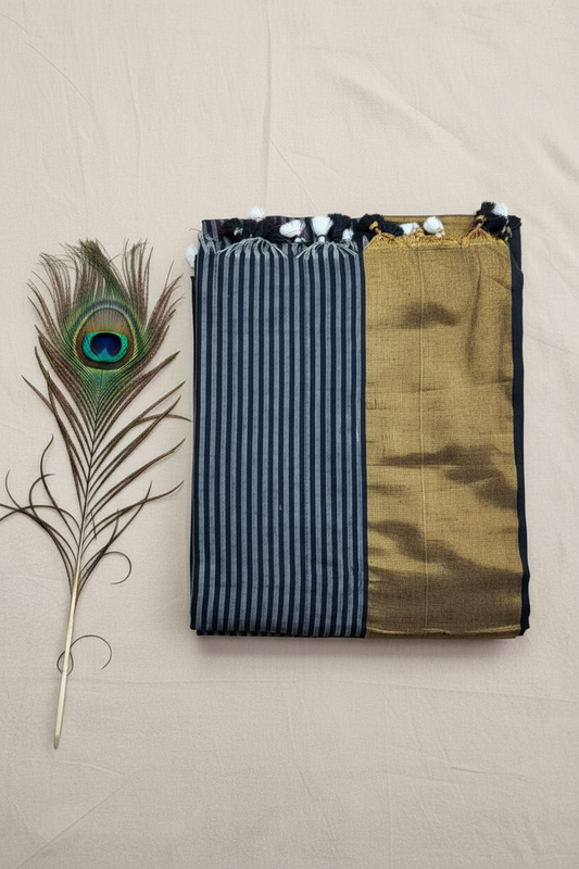 "Elegant Linen Cotton Saree featuring a rich golden zari patta border, beautifully finished with tassels on the pallu, available in vibrant colours."