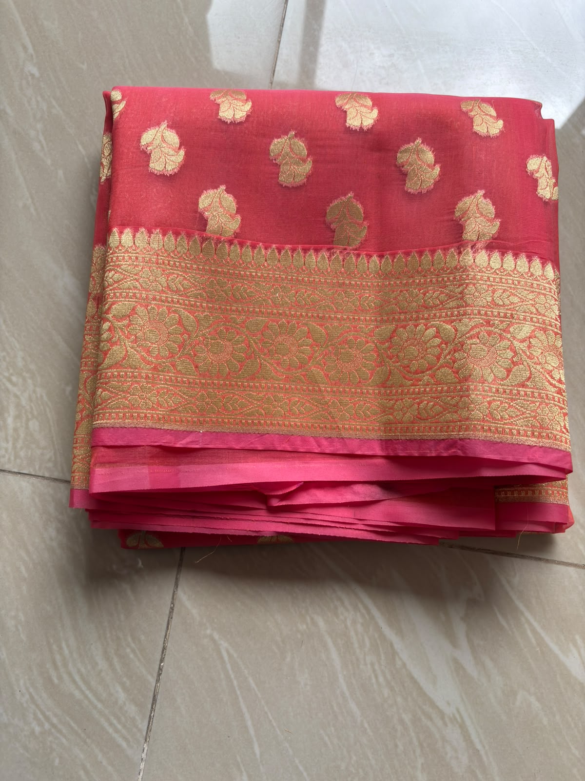 Kora organza blush orange saree with golden zari work.