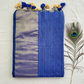 "Elegant Linen Cotton Saree featuring a rich golden zari patta border, beautifully finished with tassels on the pallu, available in vibrant colours."