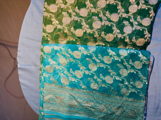 pure khaddi georgette  jaal pattern multiheaded pure benarasi sareee. color is blue and green shades merge with each other