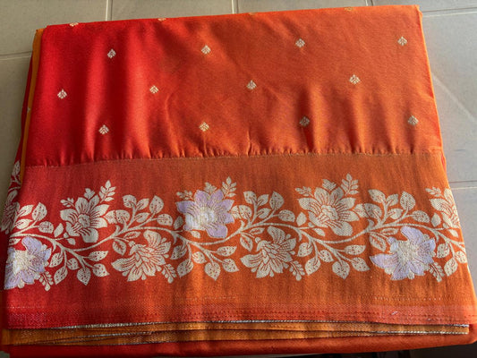 orange color pure mercerise silk banarasi saree with satin silk border . floral border zari weaving