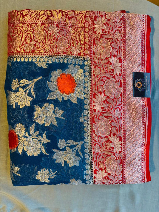 Pure khaddi goergette royal blue color banarasi saree with contrast very fresh red color .with silver zari work and velvet mina work